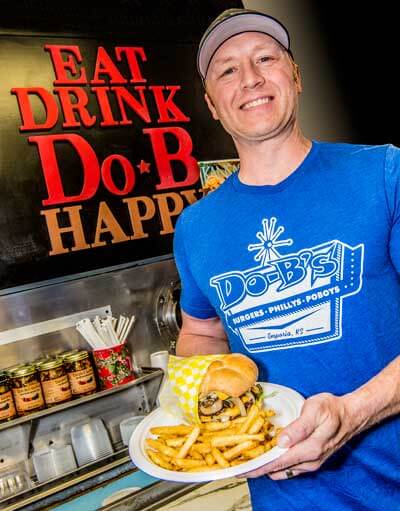 Daryn Bontrager serving a Do-B's burger