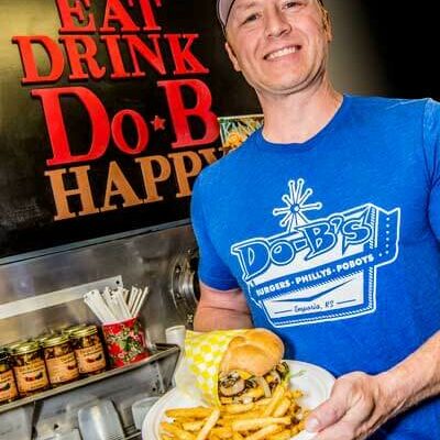 Daren Bontrager serving a Do-B's burger