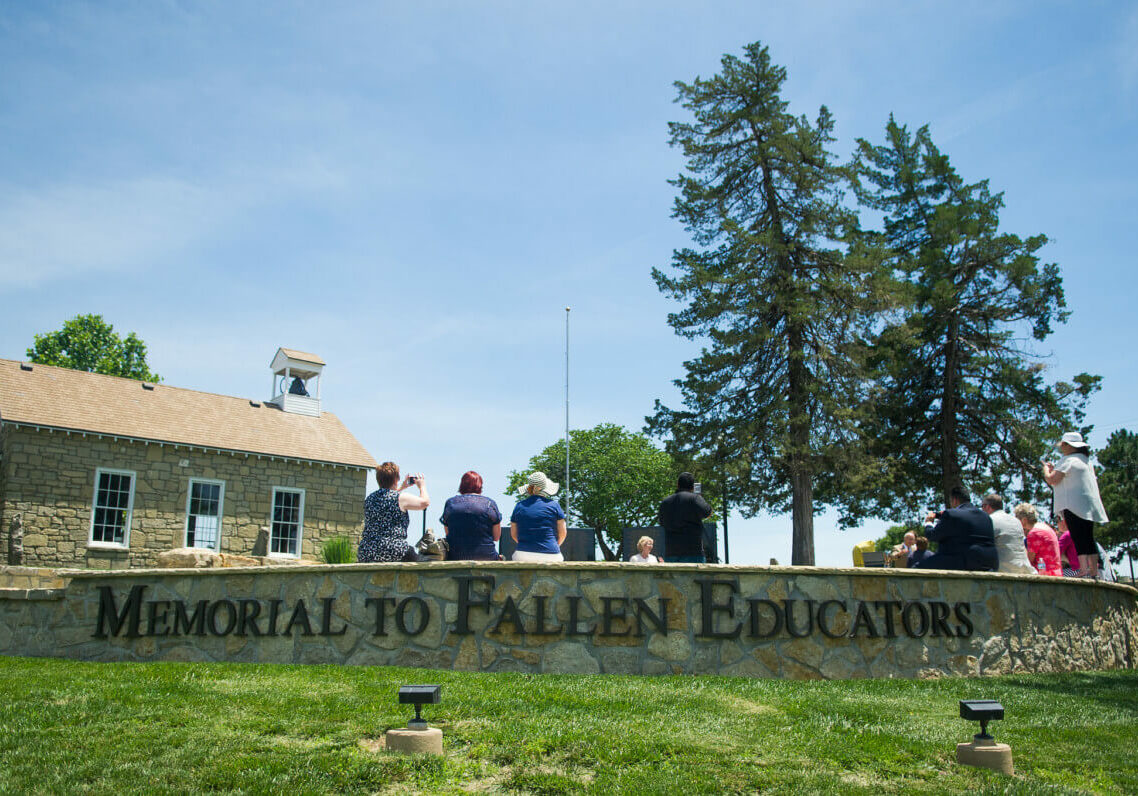 Visitors at the memorial to fallen educators on the Emporia State University campus